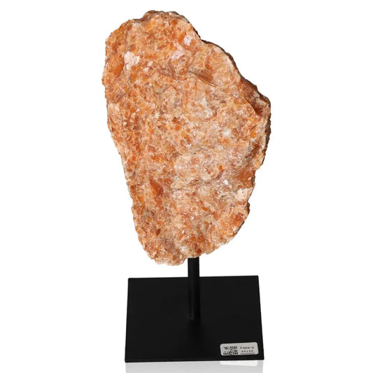 Orchid Calcite gemstone on a black metal stand, showcasing vibrant orange and pink hues for creativity and emotional balance.