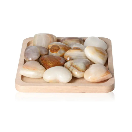 Smooth polished stones displayed on a wooden tray