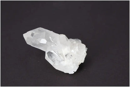 Rough crystal quartz cluster on dark background showcasing natural beauty and metaphysical power.