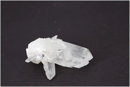 Rough Crystal Quartz Cluster on dark background, showcasing natural beauty and spiritual energy. Ideal for harmonizing environments.