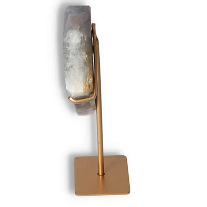 Side view of an agate decoration on a gold stand showcasing natural patterns and crystalline formations for elegant home decor.