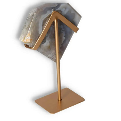 Agate decoration on a gold stand showcasing natural patterns and translucency, offering a touch of elegance and organic beauty to decor.