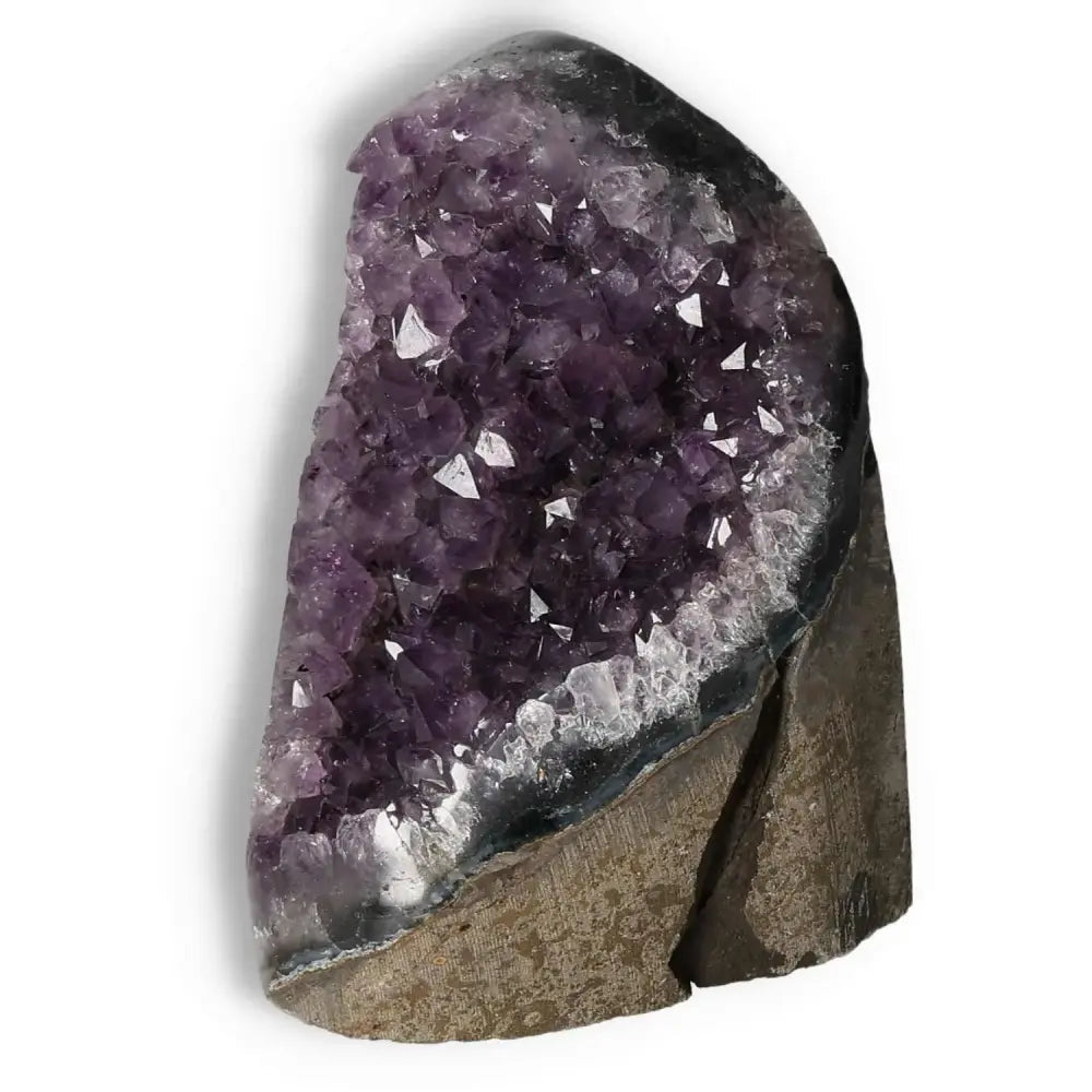 Amethyst cut base geode from Sylvia Crystals, showcasing luxurious purple crystals and natural stone base.