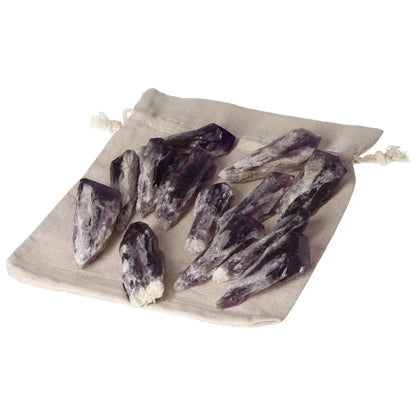 Amethyst crystals on a beige pouch, featuring 15 handpicked tips known for stress reduction and calming energy from Sylvia Crystals.