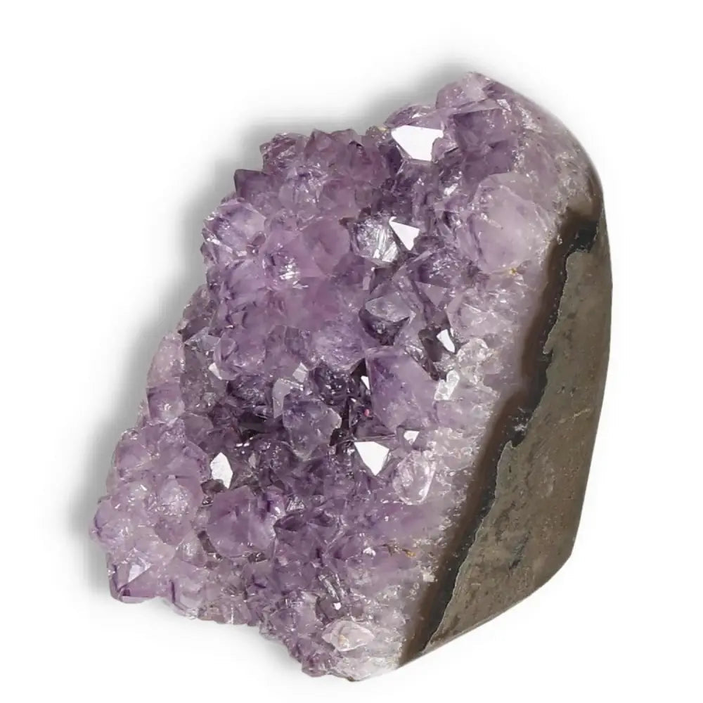Amethyst cut base geode showcasing natural purple crystals and soothing energy, Sylvia Crystals' premium luxury product.