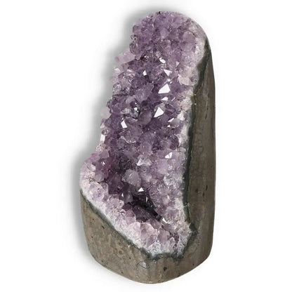Amethyst cut base geode from Sylvia Crystals showcasing purple crystal formations, known for stress reduction and energy boost.