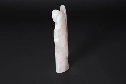 Rose Quartz angel figurine, 15 cm tall, standing upright on a black background. Ideal for harmonizing energy and purifying spaces.