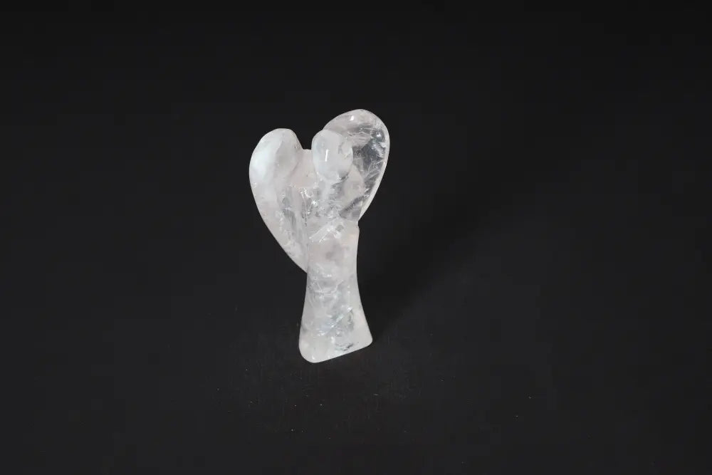 Angel-shaped rose quartz stone sculpture on a dark background, symbolizing love and emotional healing. 9 cm tall.