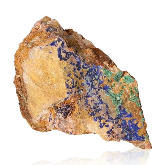 Raw azurite druzy stone displaying vibrant blue and green mineral patterns on a natural rock surface, promoting intuition and clarity.