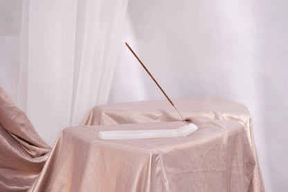 Elegant display of Bali Harmony Incense Blend stick on a satin-draped table, embodying serenity and traditional Balinese craftsmanship.