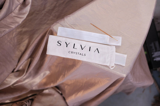Sylvia Crystals packaging with incense stick on silk fabric, enhancing serenity and elegance, perfect for spiritual ambiance.