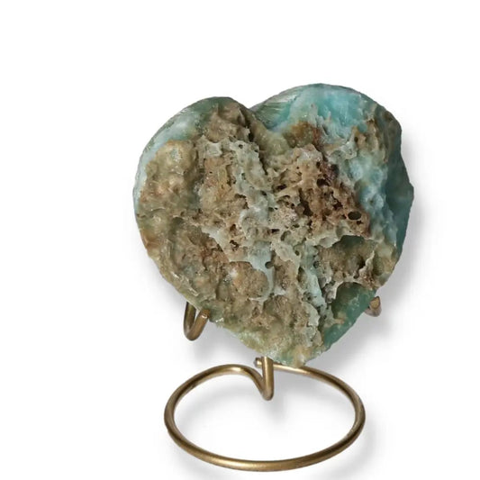 Blue Aragonite Heart crystal displaying soothing blue hues, symbolizing emotional balance and clear communication on a stand.