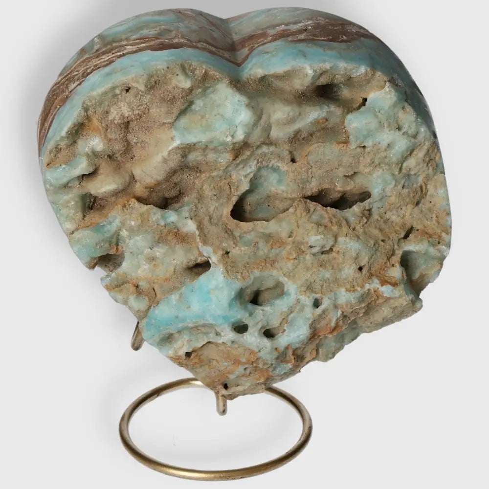 Heart-shaped Blue Aragonite crystal on a stand, showcasing its natural blue hues and textured surface for emotional balance.