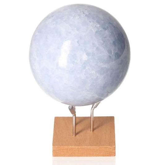 Blue Calcite Sphere on wooden stand, promoting calm, communication, and emotional healing with its soft blue hues.
