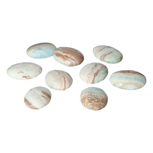 Nine Caribbean Calcite palm stones with calming blue and white swirls, ideal for meditation and emotional balance.