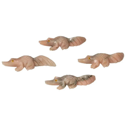 Four carved dolomite alligators showcasing exquisite craftsmanship, symbolizing tranquility and emotional balance with grounding properties.