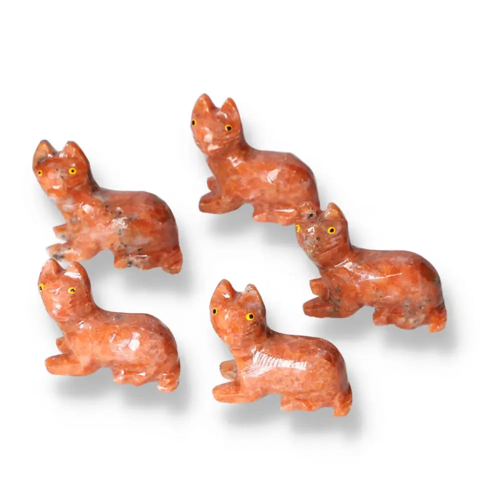 Five carved dolomite cat figurines showcasing exquisite artistry and natural beauty, promoting peace and emotional balance.