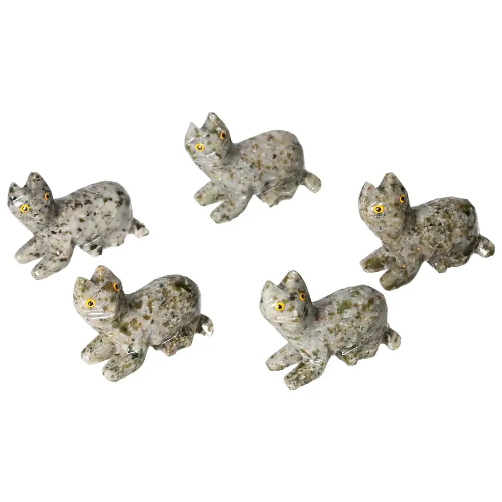 Collection of carved dolomite cat figurines with detailed craftsmanship, ideal for home decor and promoting tranquility.