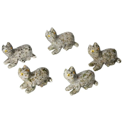 Collection of carved dolomite cat figurines with detailed craftsmanship, ideal for home decor and promoting tranquility.