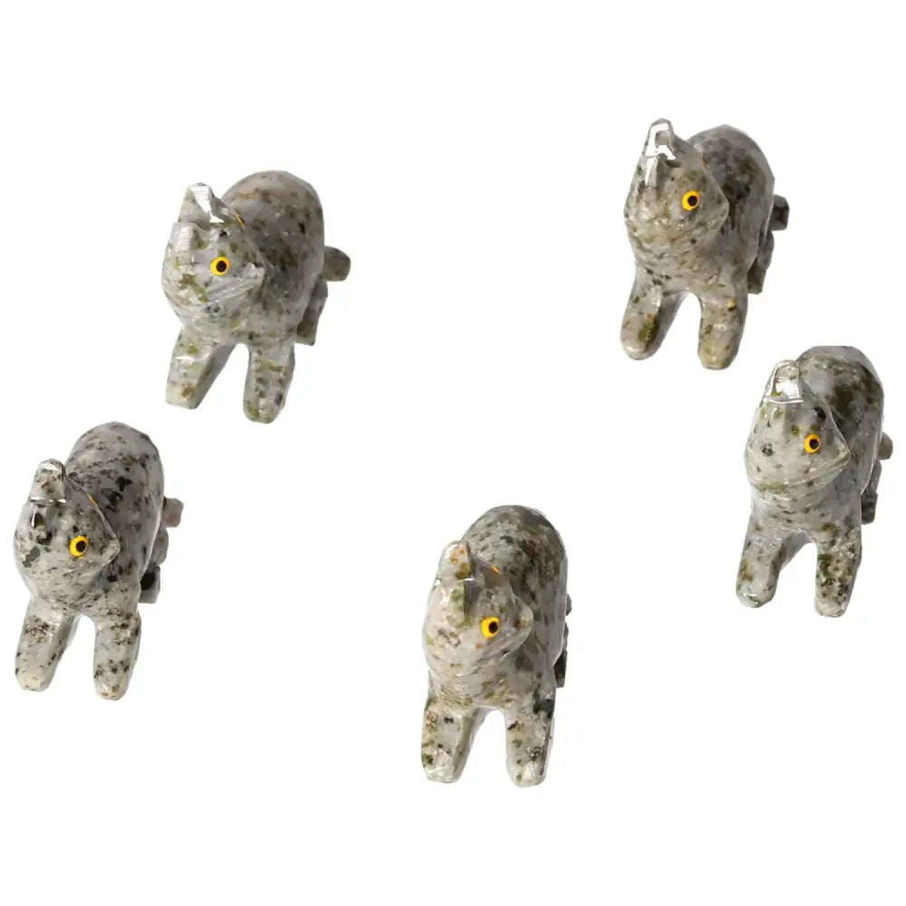 Five intricately carved dolomite cat figurines with yellow eyes, showcasing exquisite craftsmanship from Sylvia Crystals.