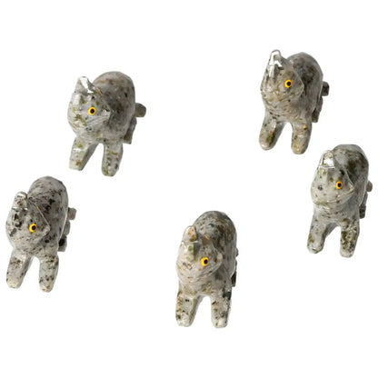 Five intricately carved dolomite cat figurines with yellow eyes, showcasing exquisite craftsmanship from Sylvia Crystals.