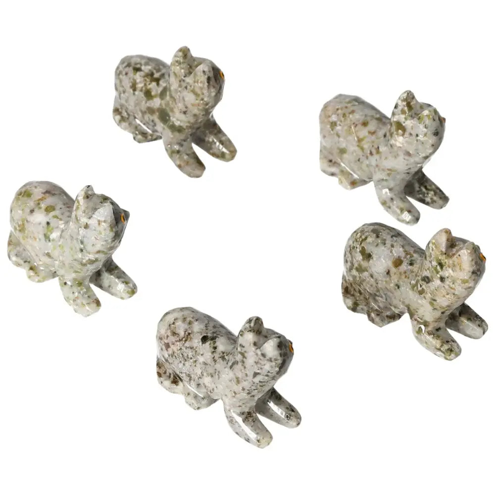 Collection of carved dolomite cat figurines displaying exquisite craftsmanship and natural beauty from Sylvia Crystals.