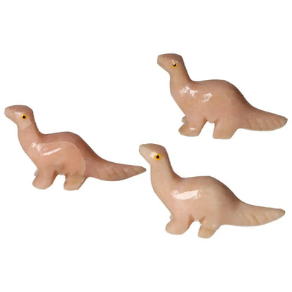 Carved Dolomite Dinosaur sculptures from Sylvia Crystals, showcasing exquisite artistry and wellness benefits in a pale pink hue.