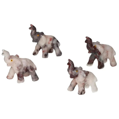 Four carved dolomite elephants from Sylvia Crystals showcasing exquisite craftsmanship and tranquil elegance.