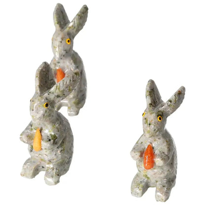 Three carved dolomite rabbit sculptures by Sylvia Crystals, enhancing décor with elegance and grounding emotional benefits.