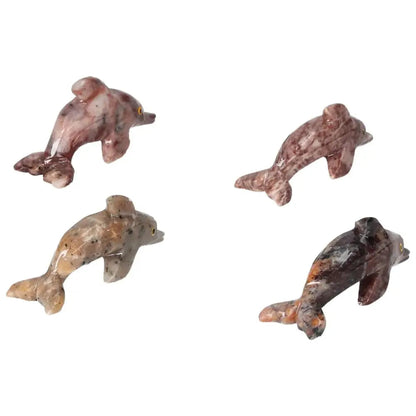Four carved magnesite dolphin figurines from Sylvia Crystals, ideal for enhancing meditation spaces with elegance and spiritual significance.