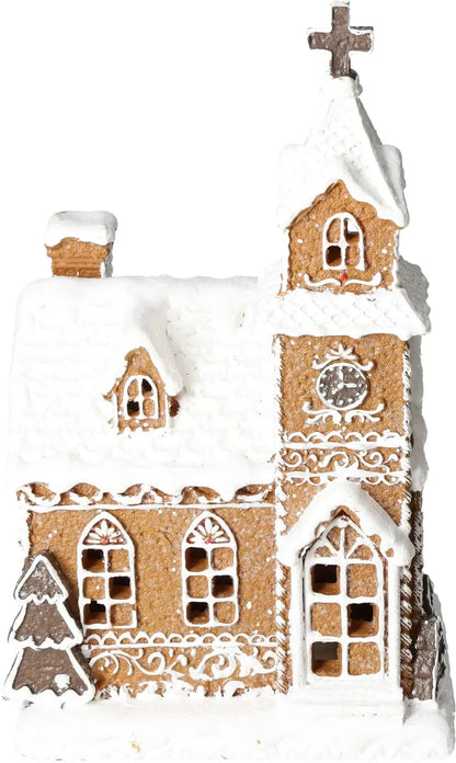 Gingerbread church with intricate icing details and a snow-covered roof, featuring a tall tower and decorative windows.