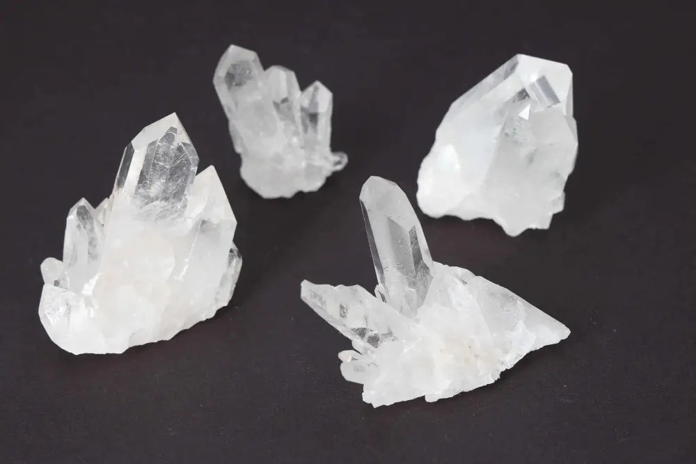Clear Quartz Cluster set of 5 on dark background, radiating high energy and purity, perfect for amplifying intentions and harmony.