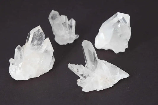 Clear Quartz Cluster set of 5 on dark background, radiating high energy and purity, perfect for amplifying intentions and harmony.
