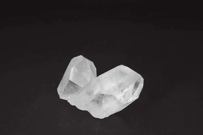 Clear Quartz Cluster on black background, showcasing crystal points for energy amplification and purification.