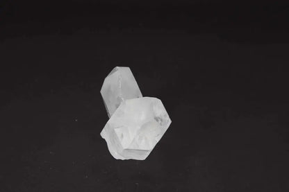 Clear Quartz Cluster on dark background, showcasing crystal points and radiant energy for purity and harmony in any space.