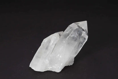 Clear Quartz Cluster with multiple crystal points on a dark background, amplifying energy and enhancing harmony in any space.
