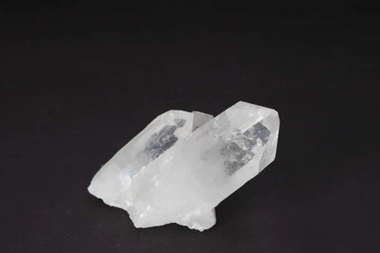 Clear Quartz Cluster with multiple crystal points on a black background, radiating purity and high vibrational energy.