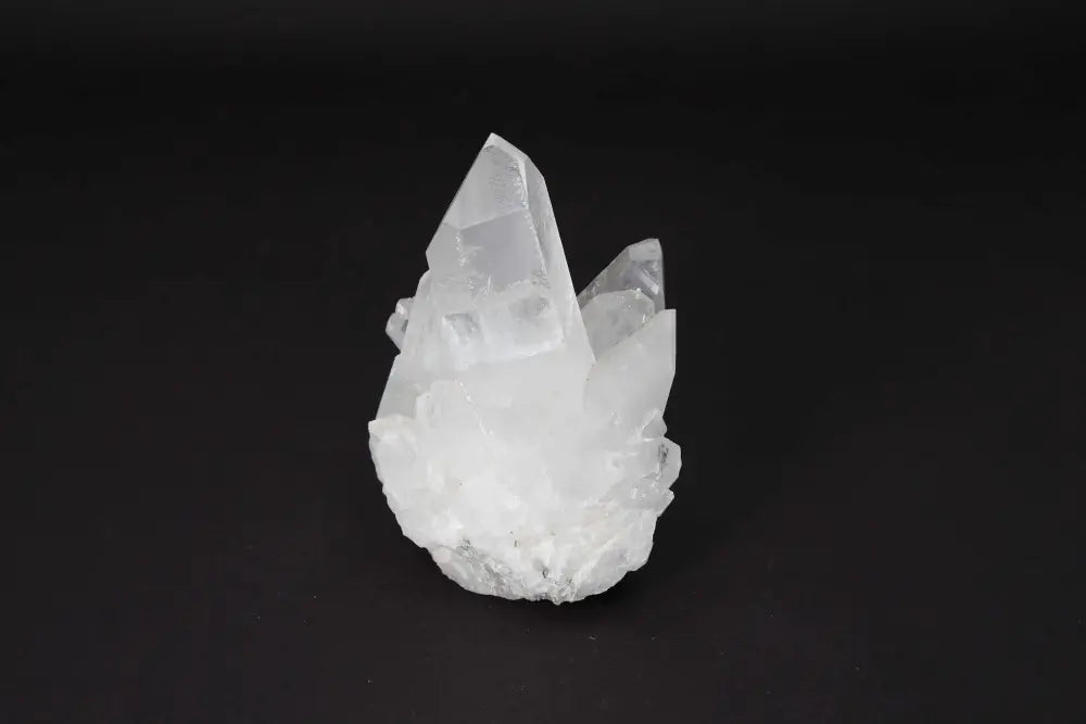 Clear Quartz Cluster featuring multiple crystal points on a shared matrix, known for amplifying energy and bringing harmony.