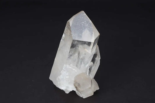Clear Quartz Cluster crystal with multiple points on dark background, radiating pure energy and high vibrational clarity.