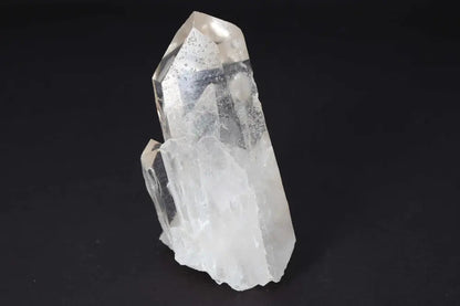 Clear Quartz Cluster with multiple crystal points, amplifying energy and radiating clarity and harmony on a black background.