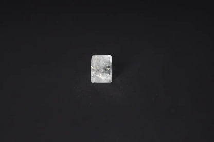 Clear Quartz Cube 2.5 cm on black background, known for purification and neutralizing negative vibrations and electromagnetic radiation.