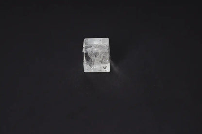 Clear Quartz Cube 3.5 cm on black background, known for purification, harmonizing energies, and neutralizing electromagnetic fields.