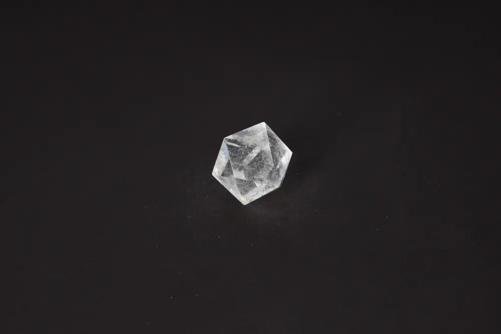 Clear Quartz Geometric Sphere 3 cm on black background, perfect for purification and harmonizing spaces, absorbing negative energy.