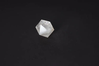 Clear Quartz Geometric Sphere 4 cm on dark background, known for purification, harmonizing energy and neutralizing negative vibrations.