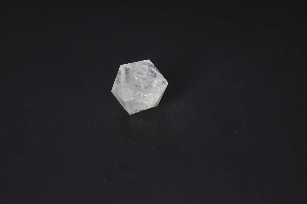 Clear Quartz Geometric Sphere 4 cm for purification and energy balancing against a dark background.