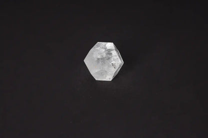 Clear Quartz Geometric Sphere 5 cm on black background, a stone known for purification and harmonizing energy, absorbing negative vibrations.