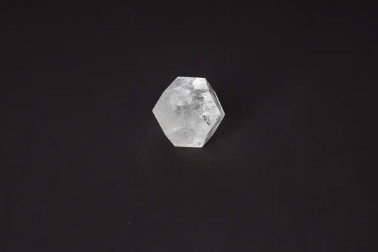 Clear Quartz Geometric Sphere 5 cm on black background, a stone known for purification and harmonizing energy, absorbing negative vibrations.