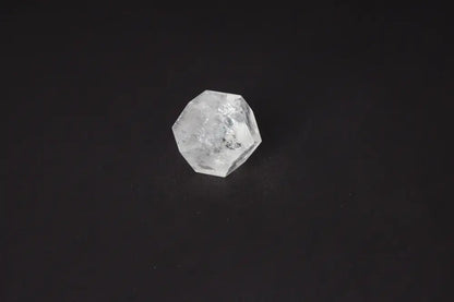 Clear Quartz Geometric Sphere 5 cm on black background, a powerful stone for purification and harmonizing energy.