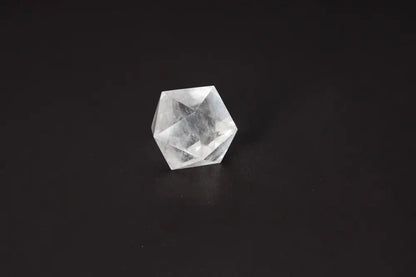 Clear Quartz Geometric Sphere 5 cm on black background, known for purification and energy harmonizing properties, dispelling negative vibes.