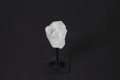 Clear Quartz on metal stand by Sylvia Crystals, highlighting luxury and spirituality with mental clarity benefits.